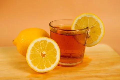 A cup of tea decorated with sliced oranges around Stock Photos