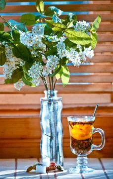 Cup of tea with emon and cherry on wooden background. Window 스톡 사진