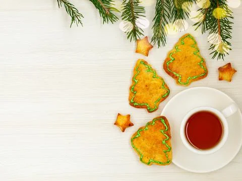 Cup of tea, fir branch and gingerbread in form of christmas tree and stars Stock Photos