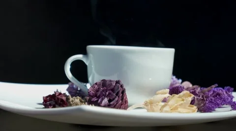 Cup of tea with flowers rotating Video stock 66778765