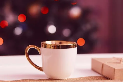 Cup of tea in front of Christmas tree. Cup mock up. Traditional holidays Stock Photos