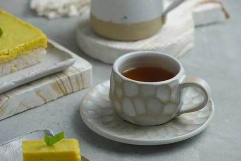 A cup of tea for on grey background. Unique cup from pottery Foto stock