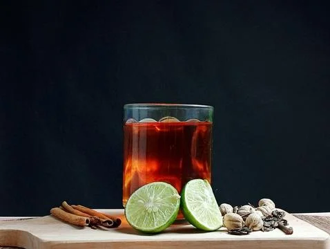A cup of tea is isolated on black with a lemonade Stock Photos