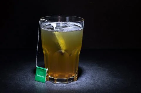 Cup of tea with a label with a dark solid background Stock Photos