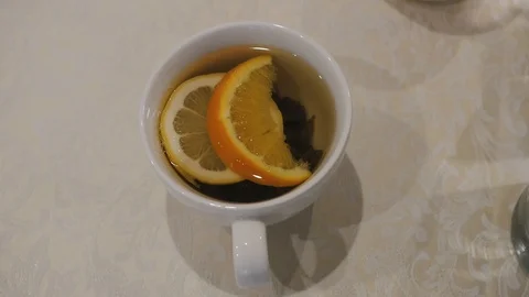 Cup of tea with lemon and orange slices Stock Footage 104755573