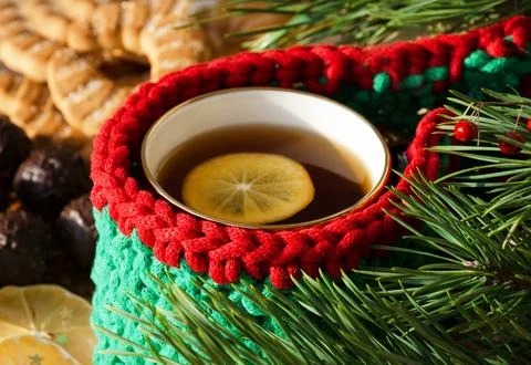 A cup of tea with lemon on a background of chocolates and cookies. Stock Photos