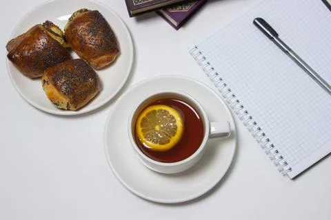 A cup of tea with lemon on a light background. Snack at work. A cup of tea at wo Stock Photos