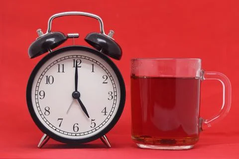 A cup of tea with lemon on a red background close-up. Steaming coffee cup on  Stock Photos