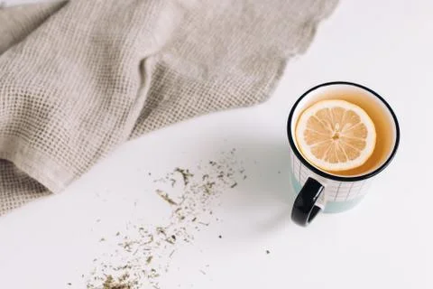 A cup of tea with lemon on white table, composition with towel Stock Photos