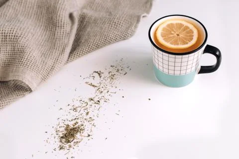 A cup of tea with lemon on white table, composition with towel Stock Photos