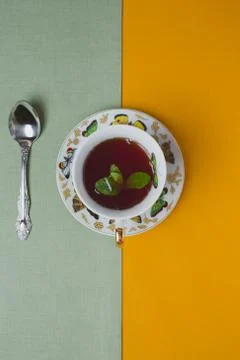 Cup of tea with mint is on a flat surface of the linen Stock Photos