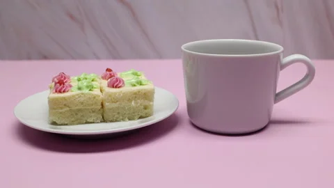 A Cup Of Tea Or Coffee On The Pink Table With Slices Of Cake. Panning Slider Sho Stock Footage 155648370