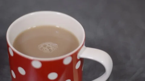 Cup of tea or coffee with spinning bubbles Stock Footage 86694380