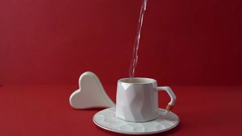 Cup of tea or coffee with white heart on red. Valentine's day celebration Stock Footage 168396750