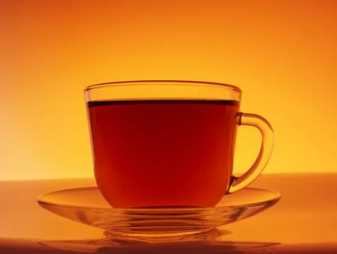 Cup of tea on orange background Stock Photos