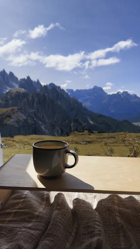 Cup of tea with panoramic view of Tre Cime di Lavaredo Dolomites landscape. Stock Footage 330437465