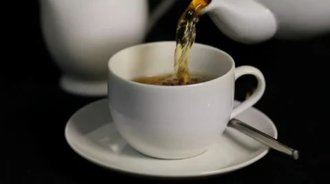 Cup of tea, Pouring Tea from a white teapot and Milk into Tea Cup, Stock Footage 882498