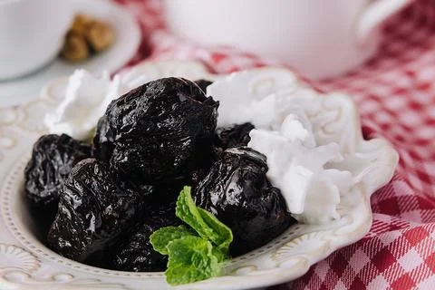 Cup of tea with prunes close up Stock Photos
