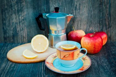 A cup of tea, rose hips, apples and a kettle. Vitamins, disease prevention Stock Photos