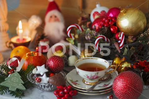 A Cup Of Tea With A Rose Pattern, Christmas Biscuits And Christmas Decorations