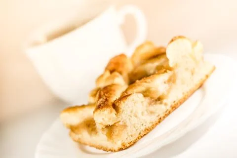 A cup of tea, a saucer with a pie Stock Photos