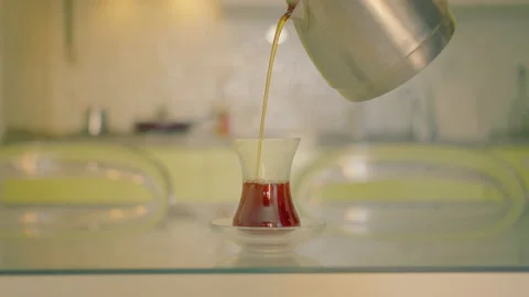 Cup for tea with a saucer stands on the table, backdrop kitchen Stock Footage 219270656