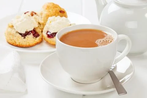A cup of tea with scones, jam and cream. Stock Photos