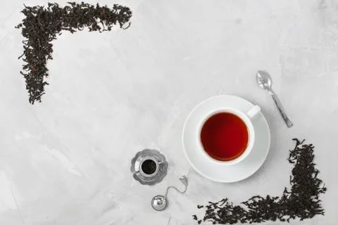 Cup of tea silver spoon little teapot on concrete background. Stock Photos