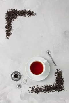 Cup of tea silver spoon little teapot on concrete background. Stock Photos