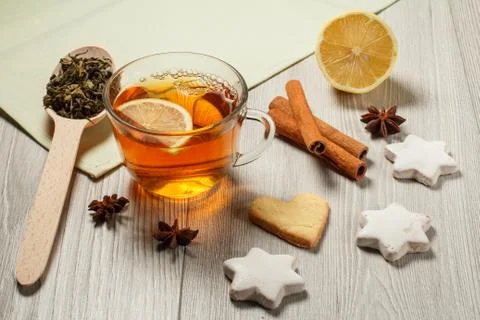 Cup of tea with slice of lemon, gingerbread cookies in star and cinnamon Stock Photos