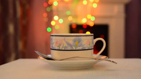 A Cup of tea with smoke on the background of bokeh. Christmas Stock Footage 142647575
