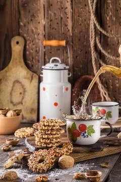 Cup of tea with a splash and biscuits with nuts Stock Photos