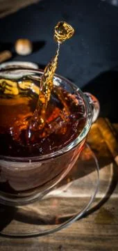 Cup of tea with splash Stock Photos