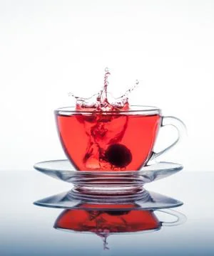 Cup of tea with splashes Stock Photos