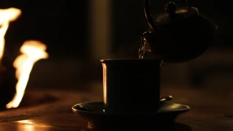 Cup of tea standing near fire. Video stock 274468440