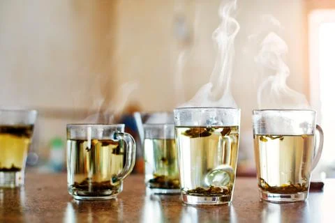 Cup of tea with steam Stock Photos