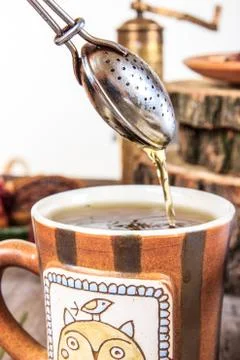 Cup of tea with strainer Stock Photos