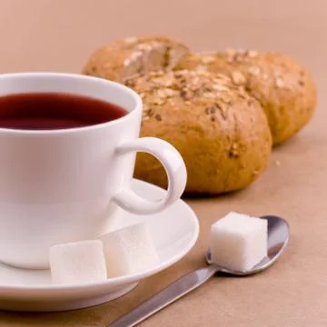 Cup of tea, sugar and bread Stock Photos