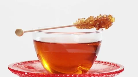 A cup of tea with a sugar swizzle stick Stock-Footage 8570965