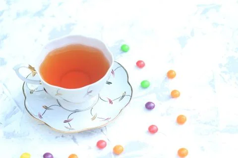 Cup of tea with sweets on a light background. Stock Photos
