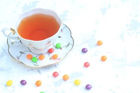 Cup of tea with sweets on a light background. Stock Photos