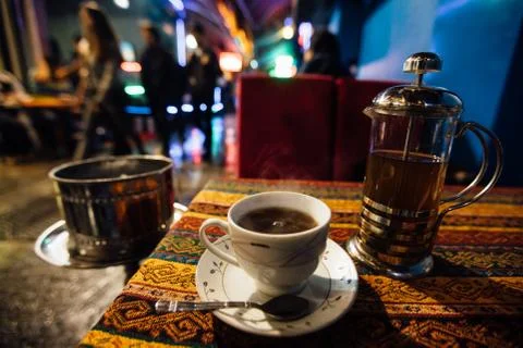 A cup of tea on the table next to the hookah. Atmospheric street cafe Stock Photos