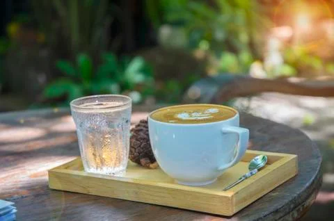 Cup with tea on table over mountains landscape with sunlight. Beauty nature b Stock Photos