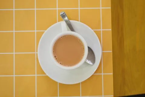 Cup of tea on a table with yellow grid pattern 写真素材