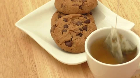 Cup of tea with tea bag and cookies Stock Footage 53336903