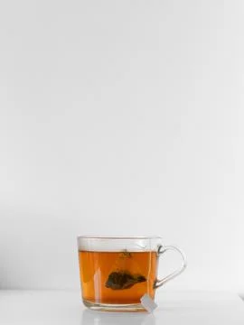 A cup of tea with a tea bag in it Stock Photos