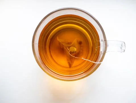 A cup of tea with a tea bag in it Stock Photos
