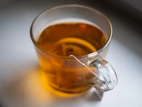 A cup of tea with a tea bag in it Stock Photos
