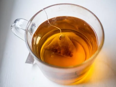 A cup of tea with a tea bag in it Stock Photos