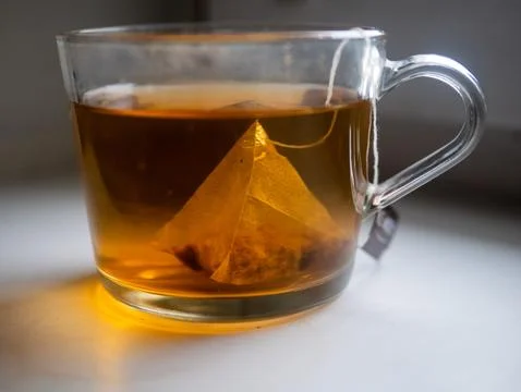 A cup of tea with a tea bag in it Stock Photos